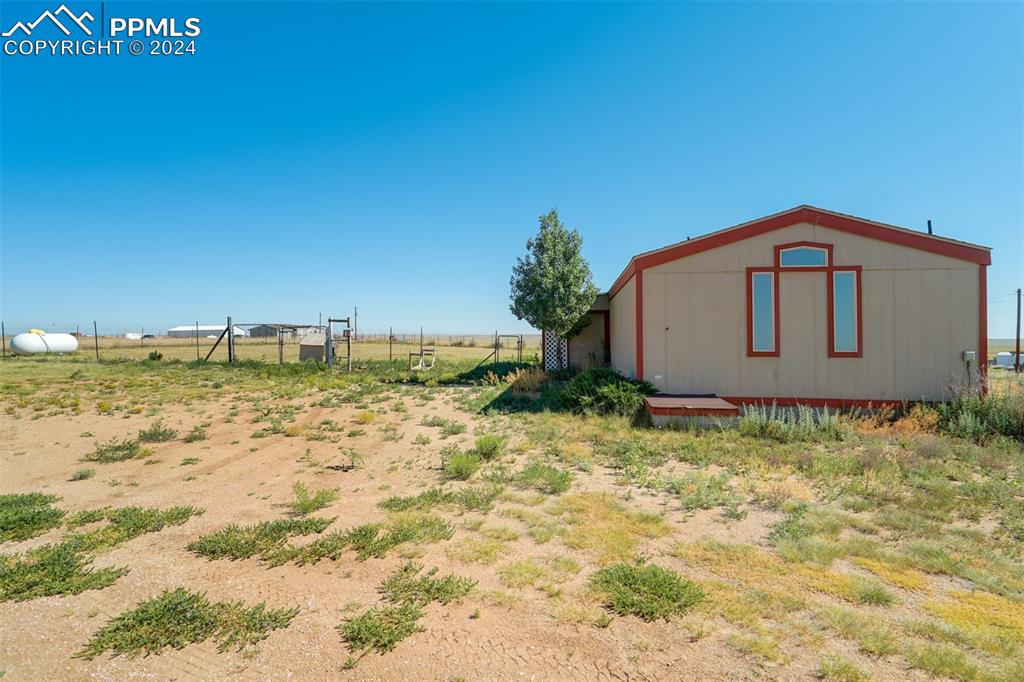 6240 Night Train Lane Yoder, CO 80864 - Photo 41 of 50 a view of a house with a yard