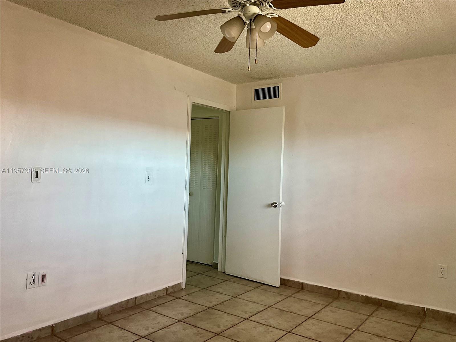 1910 West 56th Street, Unit 3302 Hialeah, FL 33012 - Photo 16 of 19 an empty room with chandelier fan