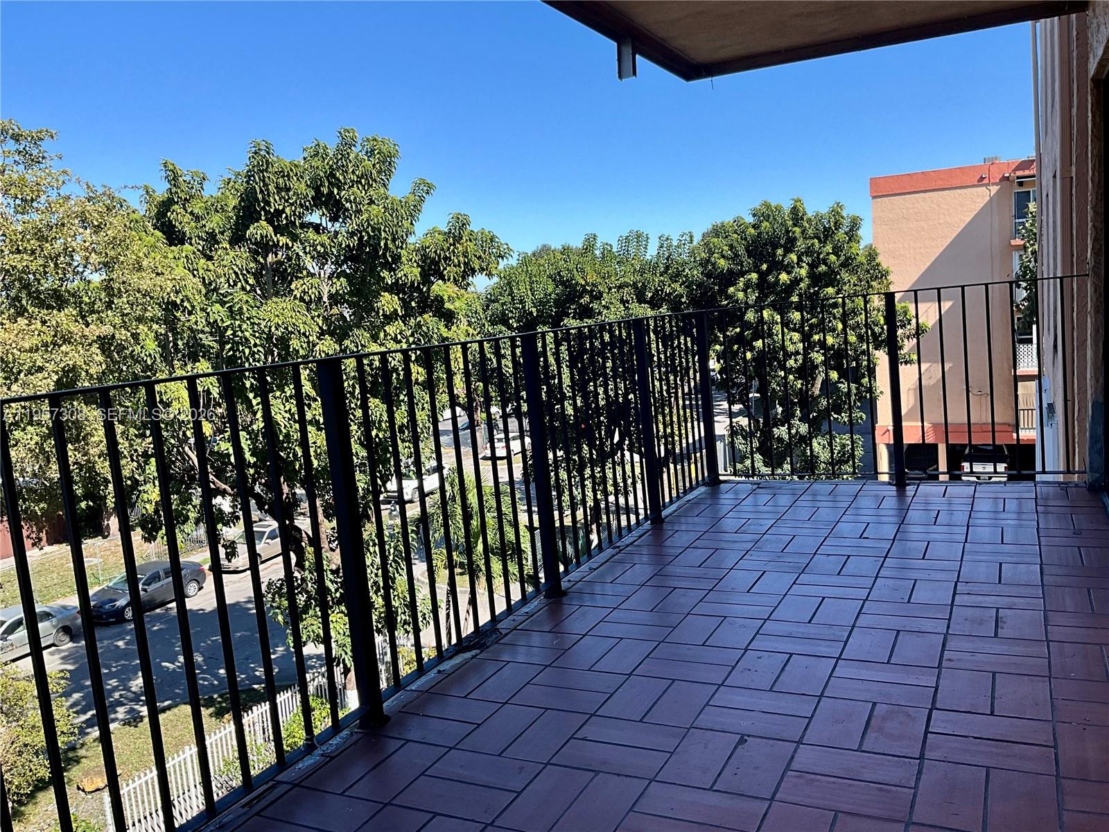 1910 West 56th Street, Unit 3302 Hialeah, FL 33012 - Photo 5 of 19 a view of a pathway with a wrought fence