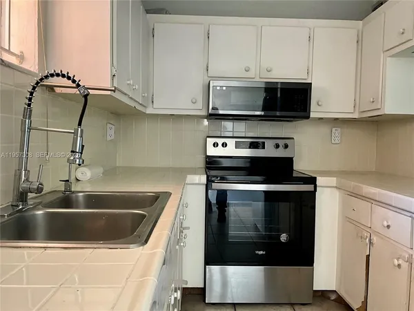 a white refrigerator freezer sitting inside of a kitchen