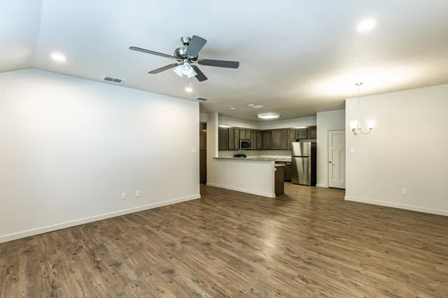 a view of kitchen with microwave and refrigerator