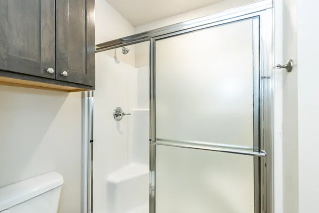 a bathroom with a glass shower door