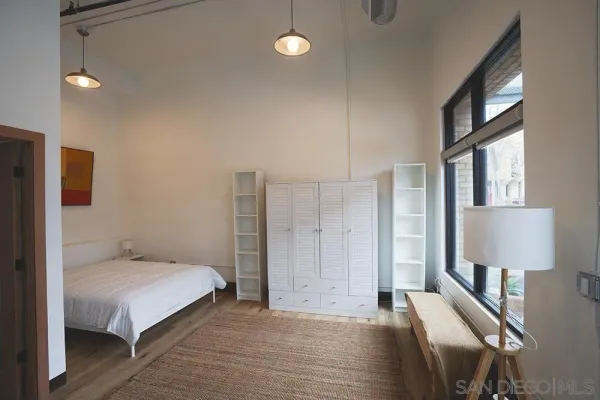 a room with a bed and a lamp on table
