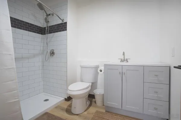 a bathroom with a sink toilet and shower