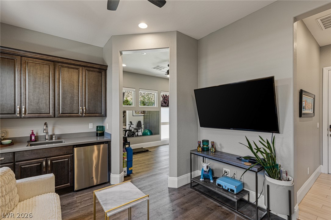 10118 Copper Edge Road Las Vegas, NV 89148 - Photo 21 of 48 Custom cabinetry and a convenient bar fridge complement this versatile room, ideal for entertaining or daily living.