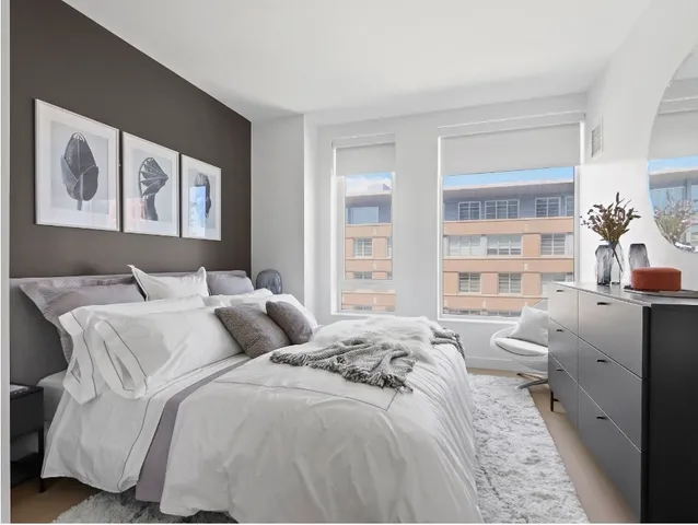 a bedroom with a bed and a window