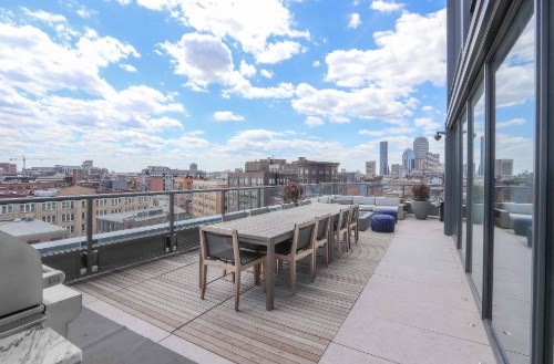 390 Harrison Avenue, Unit 416 Boston, MA 02118 - Photo 10 of 12 a view of a balcony with wooden benches