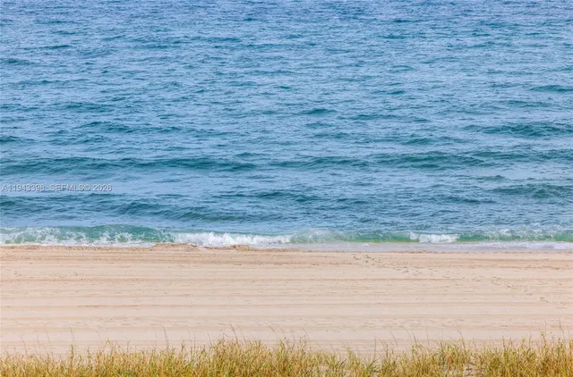 a living room with furniture a flat screen tv and a lamp