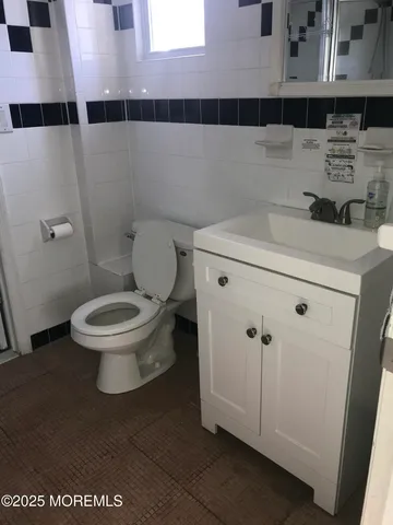 a bathroom with a toilet and a mirror