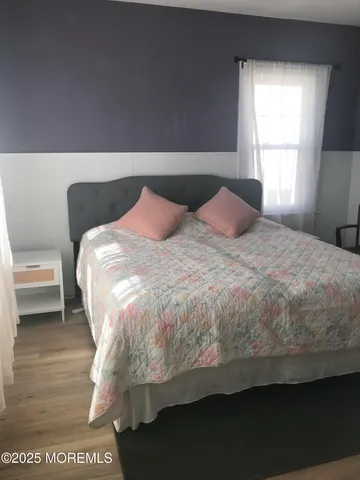 a large bed sitting in a bedroom next to a window