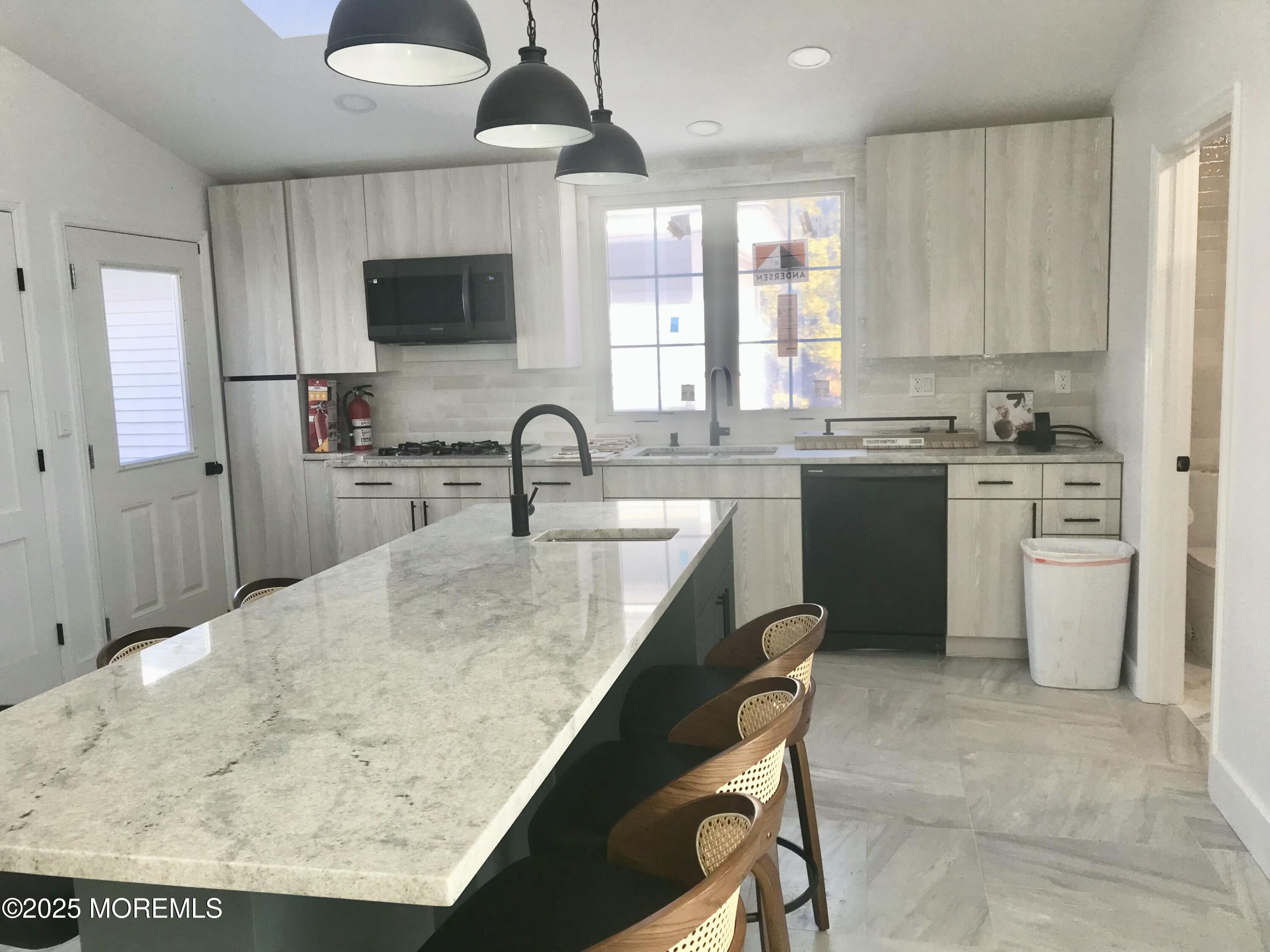 11 Lakeview Road Deal, NJ 07723 - Photo 10 of 15 a kitchen with a table chairs sink and cabinets