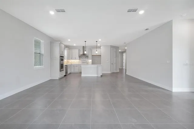 a view of a kitchen with a sink and a refrigerator