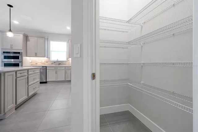 a bathroom with a granite countertop sink mirror and toilet