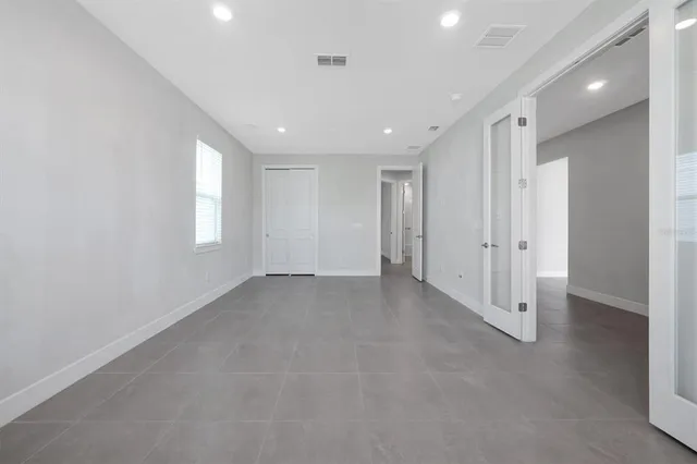a view of an empty room and a window
