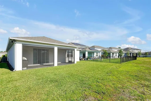 a view of a house with a yard and lake view