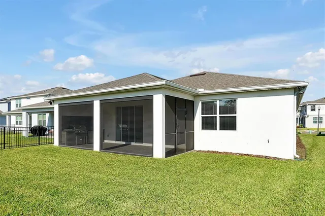 a aerial view of a house next to a yard