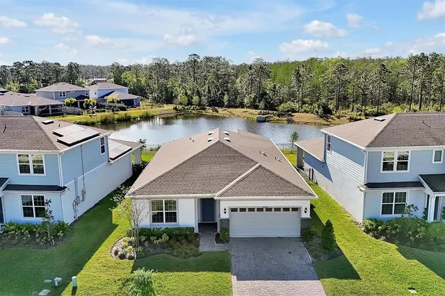 an aerial view of multiple houses with a yard