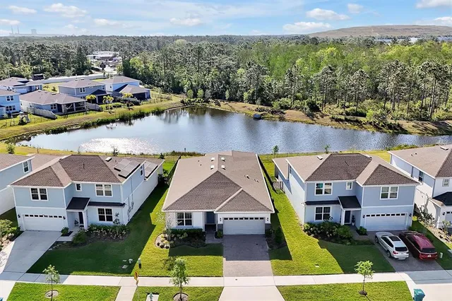 an aerial view of a house with a yard