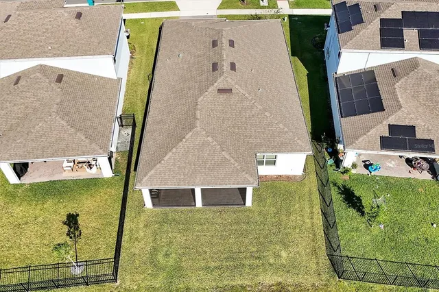 an aerial view of residential houses with outdoor space and swimming pool