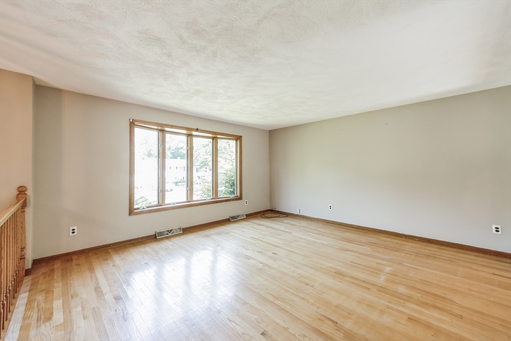 9 Bear Hill Road Billerica, MA 01821 - Photo 6 of 29 an empty room with wooden floor and windows