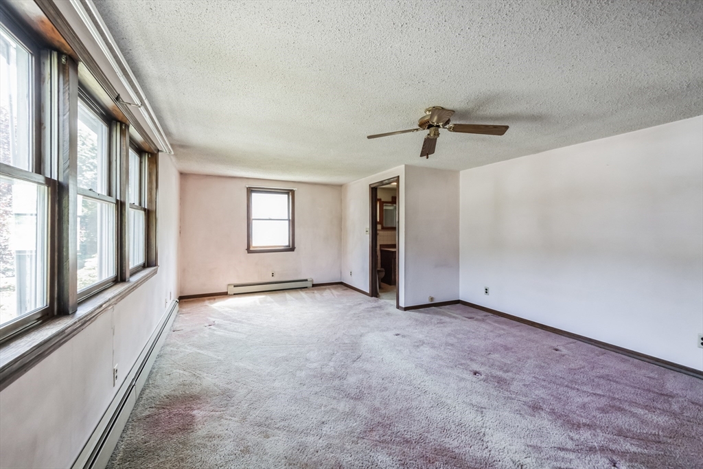 9 Bear Hill Road Billerica, MA 01821 - Photo 9 of 29 a view of a big room with windows and chandelier fan