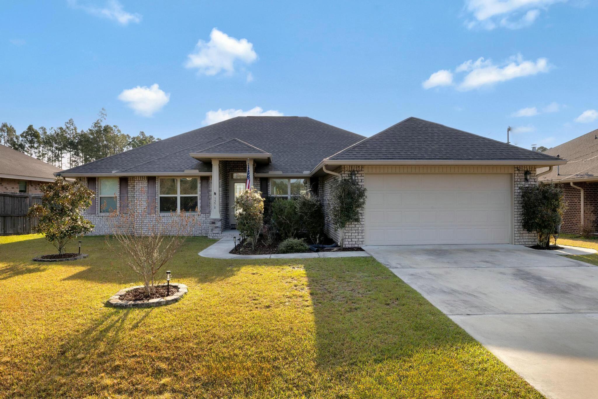 a view of a house with swimming pool and a yard