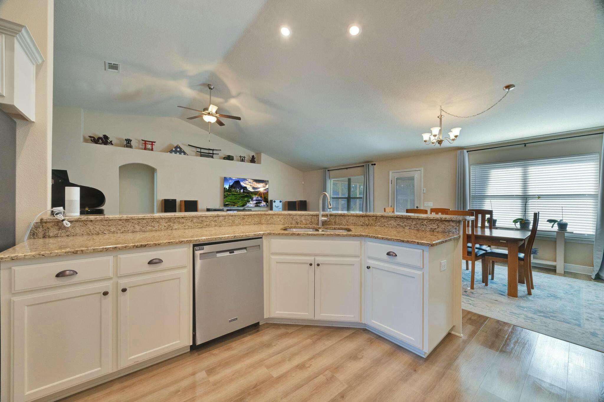 3278 Main Street Navarre, FL 32566 - Photo 14 of 43 a spacious bathroom with a granite countertop sink and a mirror
