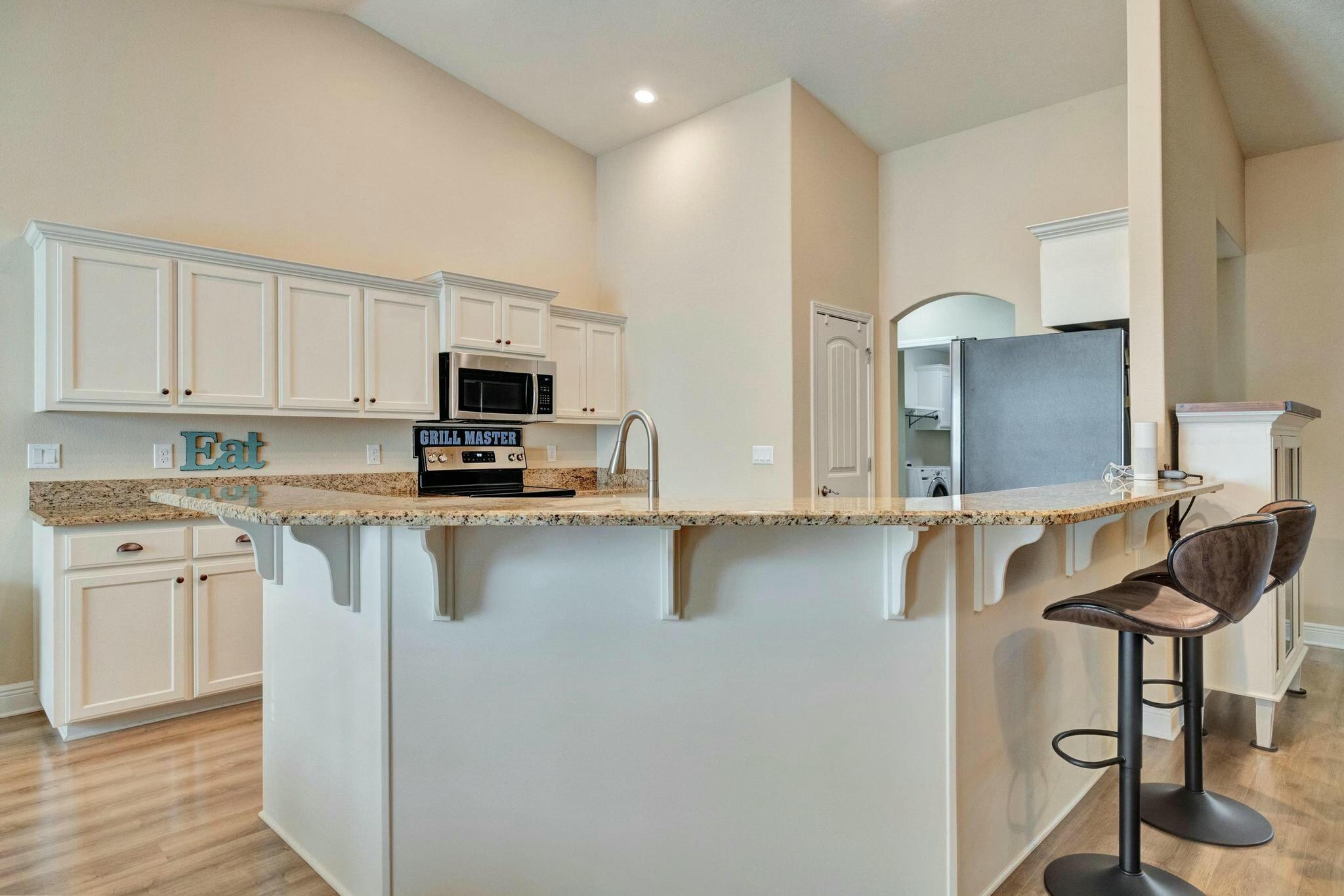3278 Main Street Navarre, FL 32566 - Photo 18 of 43 a kitchen with stainless steel appliances granite countertop a sink and a stove