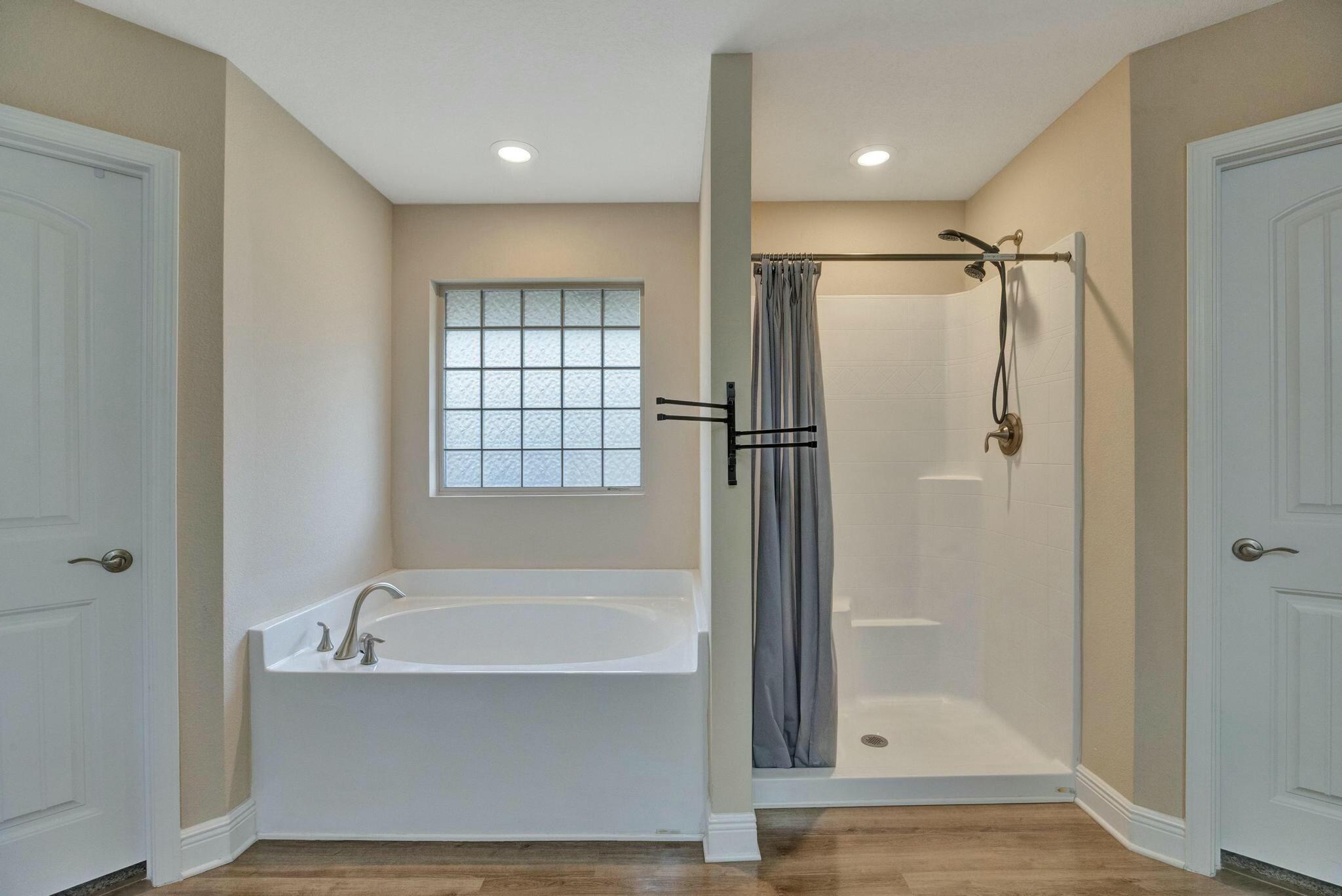 3278 Main Street Navarre, FL 32566 - Photo 24 of 43 a bathroom with a bathtub and a shower