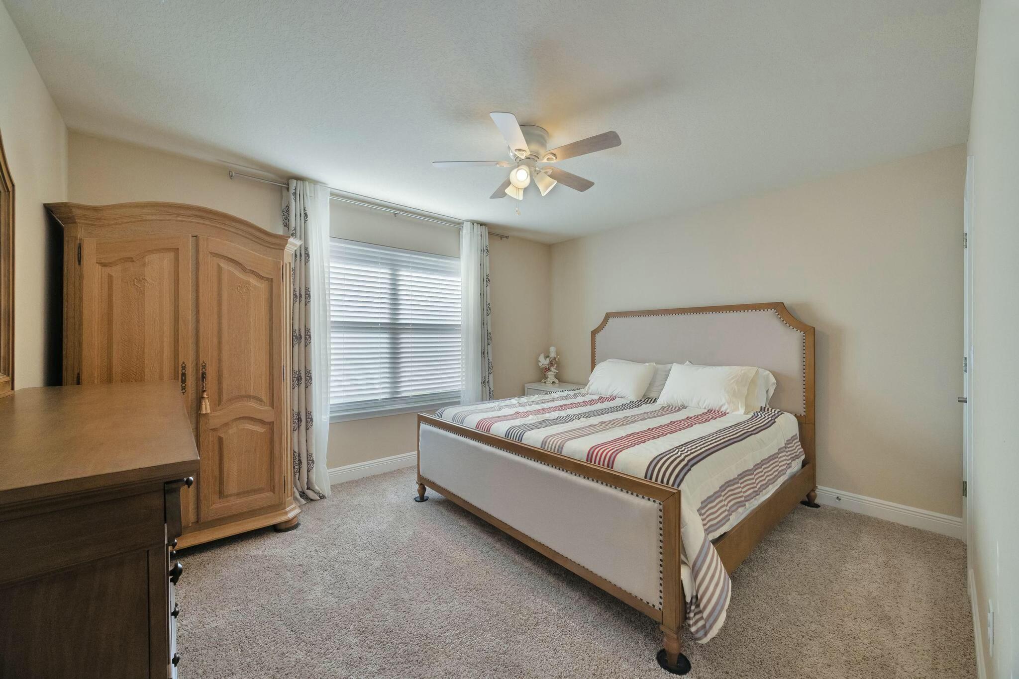 3278 Main Street Navarre, FL 32566 - Photo 26 of 43 a bedroom with a bed and a cabinets