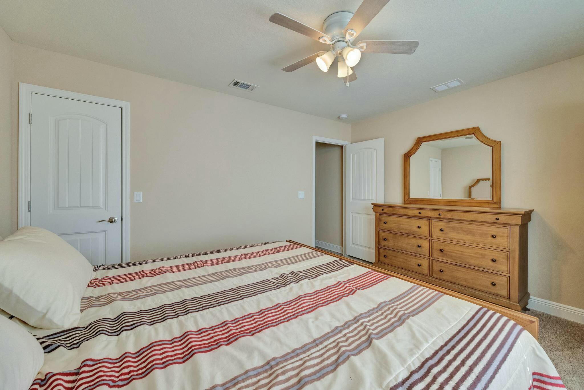 3278 Main Street Navarre, FL 32566 - Photo 27 of 43 a bedroom with a bed and a dresser