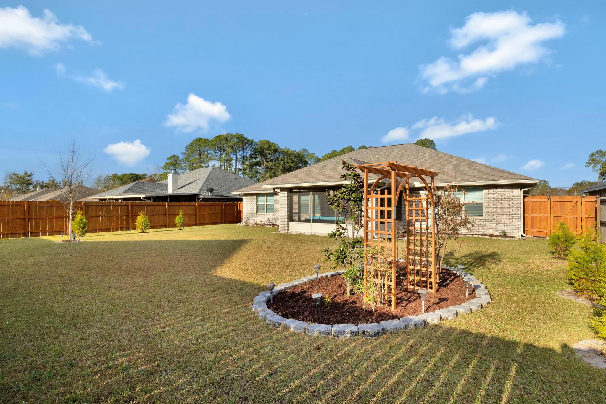 3278 Main Street Navarre, FL 32566 - Photo 35 of 43 a front view of a house with a yard