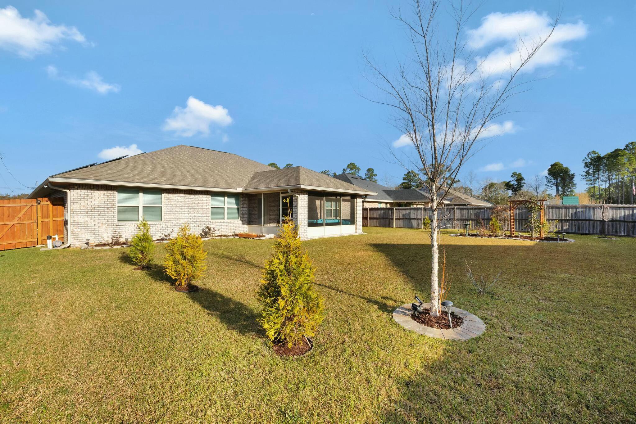 3278 Main Street Navarre, FL 32566 - Photo 36 of 43 a front view of a house with garden