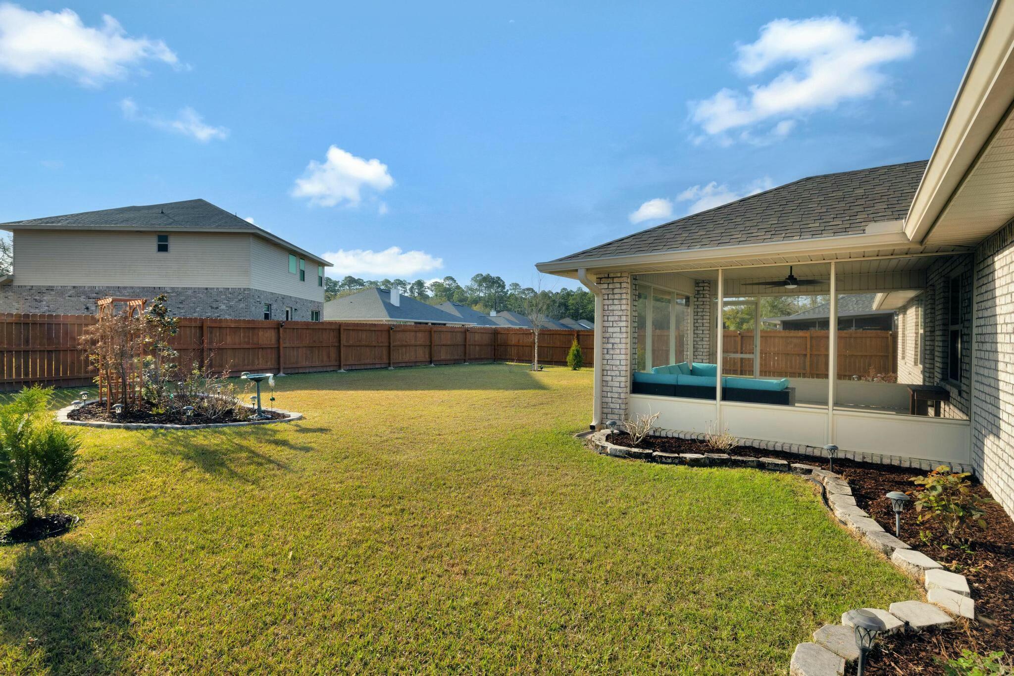 3278 Main Street Navarre, FL 32566 - Photo 37 of 43 a view of a house with swimming pool and a yard