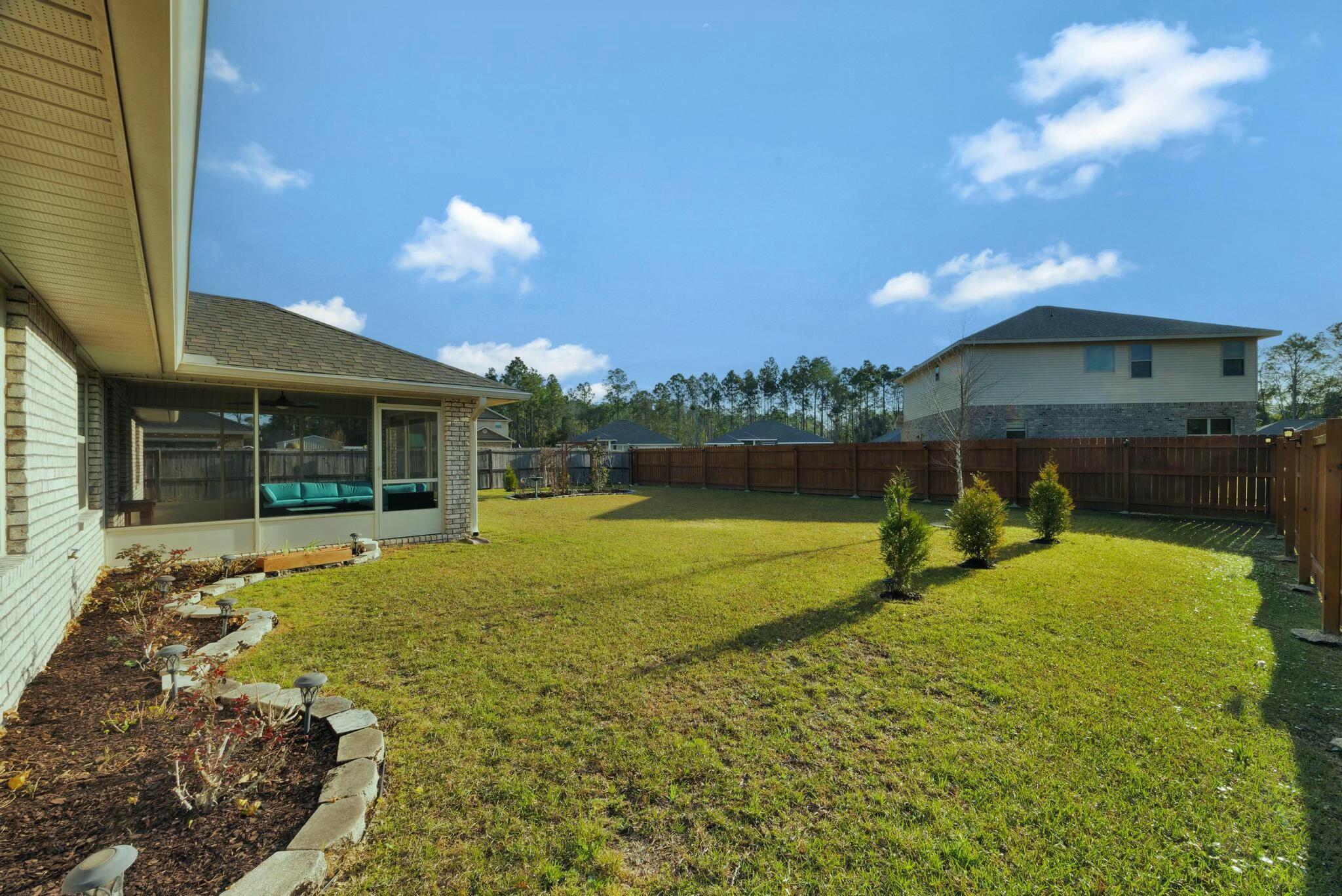 3278 Main Street Navarre, FL 32566 - Photo 38 of 43 a view of a house with a yard