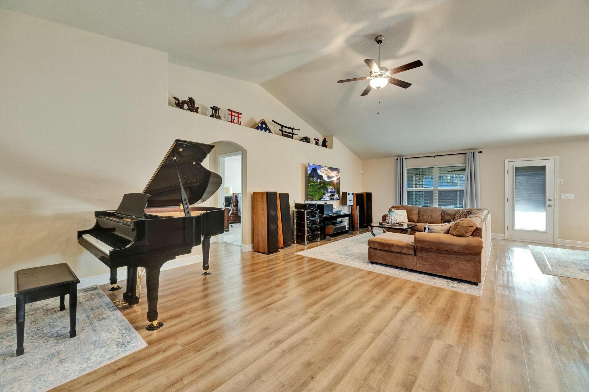 3278 Main Street Navarre, FL 32566 - Photo 5 of 43 a living room with furniture and a wooden floor