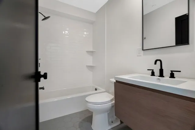 a bathroom with a toilet a sink and a bathtub