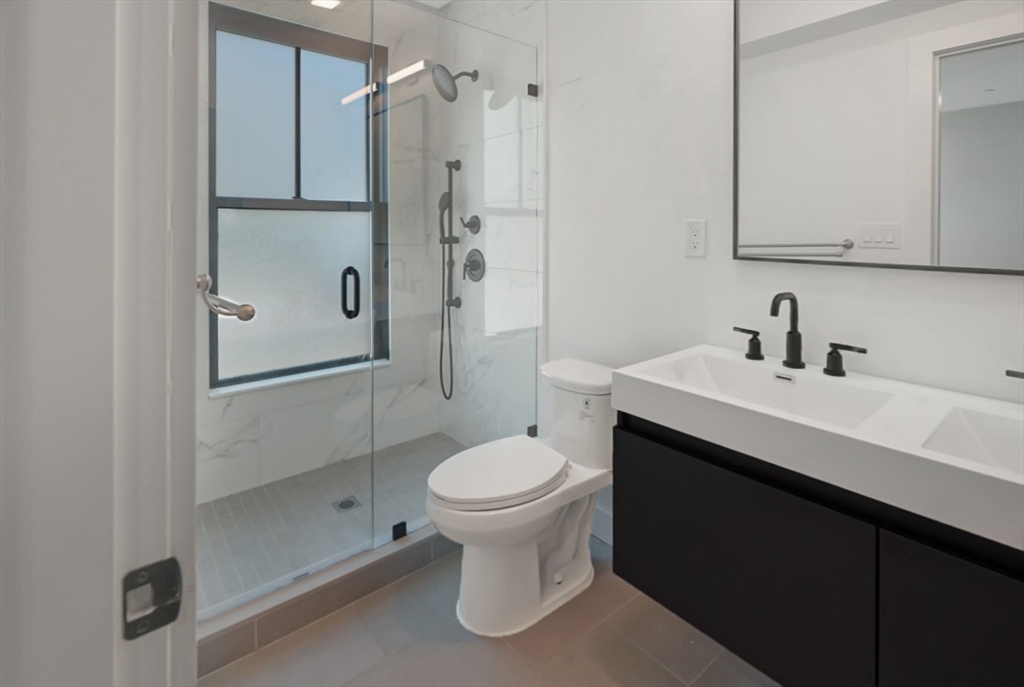 173 Magnolia Street, Unit 1 Boston, MA 02125 - Photo 7 of 9 a bathroom with a sink toilet and shower