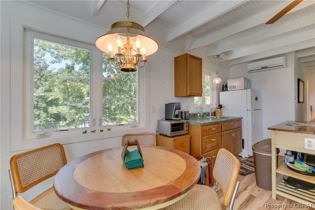 5403 Ark Road Gloucester, VA 23061 - Photo 36 of 50 Dining area with beam ceiling, & light hardwood flooring.