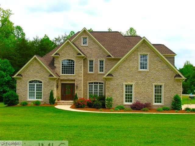 8203 Haw River Road Oak Ridge, NC 27310 - Photo 1 of 16 Exterior Front. Builders Personal Home with tons of upgrades. Over an Acre Lot, beautifully landscaped.