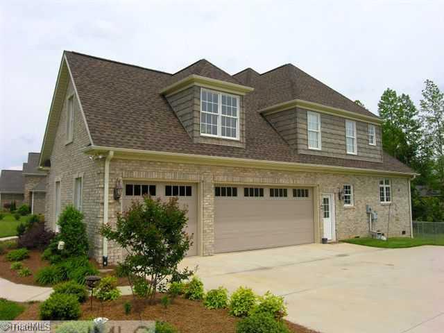 8203 Haw River Road Oak Ridge, NC 27310 - Photo 3 of 16 Exterior Front. 3-Car Garage with room for additional storage