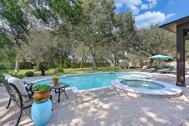 a view of a house with sitting area and swimming pool