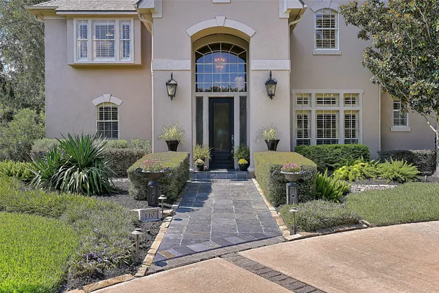 a front view of a house with garden