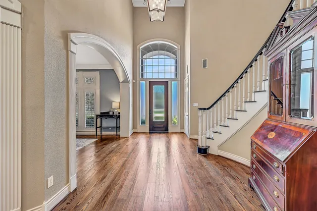a view of entryway and hall with wooden floor