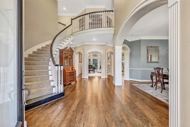 a view of a hallway view with wooden floor and staircase