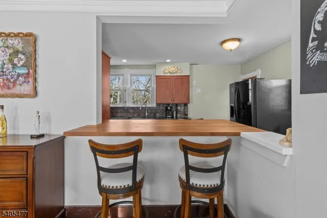 a view of a big house with a big yard and large trees