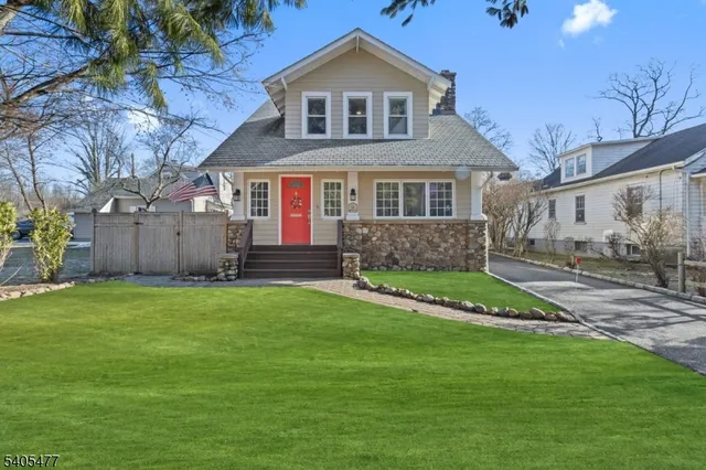 a living room with furniture and two large window
