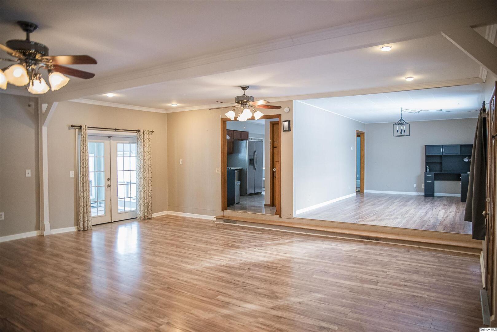 700 North 66th Street Quincy, IL 62305 - Photo 3 of 11 a view of an empty room with wooden floor and a window