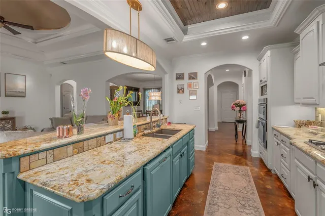 a bathroom with a granite countertop sink a large mirror and a shower