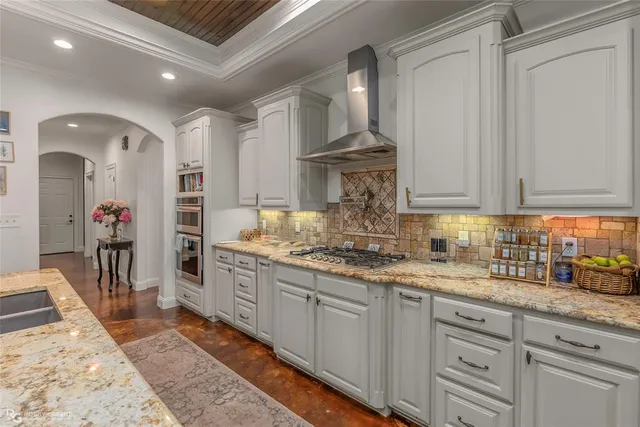 a kitchen with sink stove and cabinets